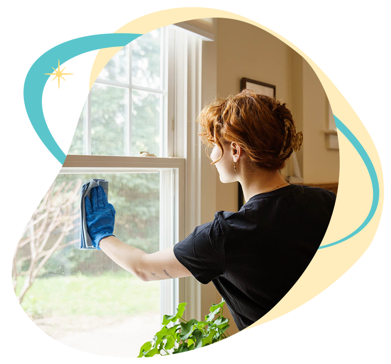 Belle Home cleaner wiping down a window